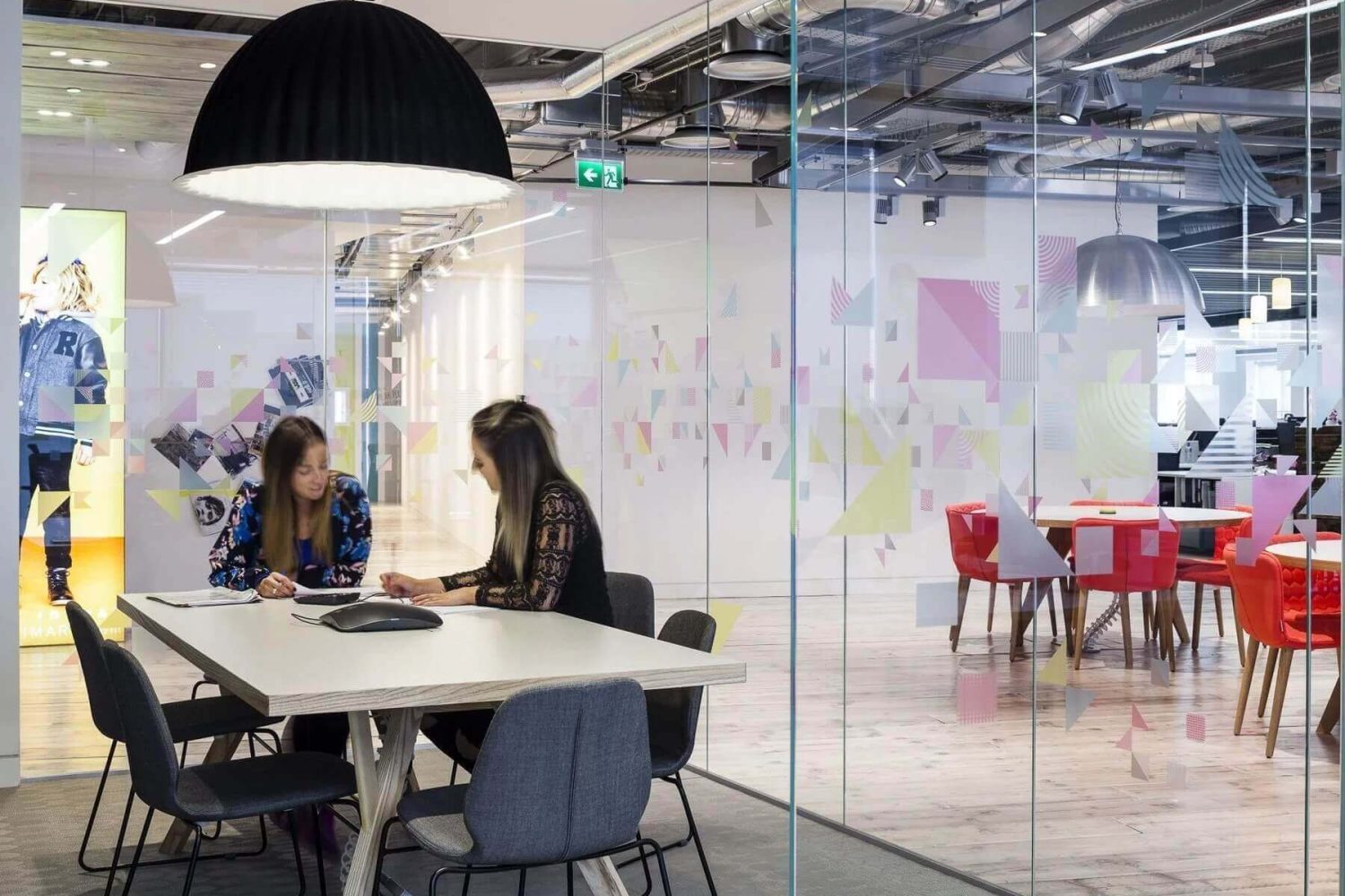 2 colleagues working in LED lit office space