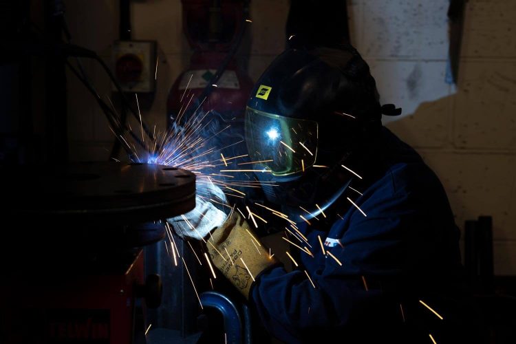NGA engineer working in protective clothing and helmet.