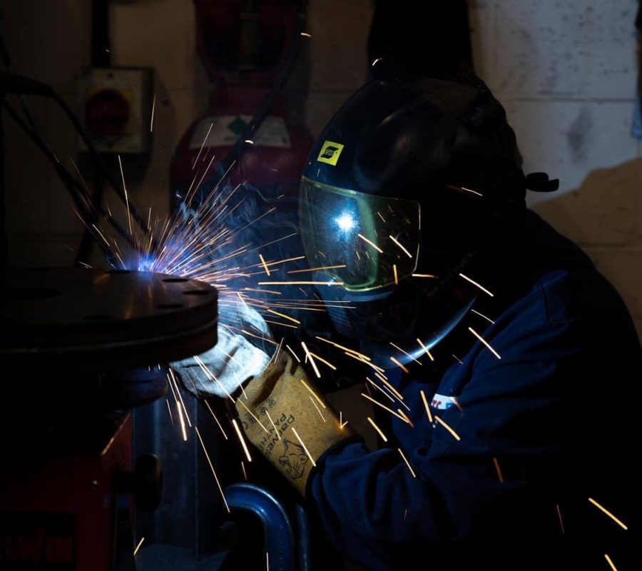 NGA engineer working in protective clothing and helmet.